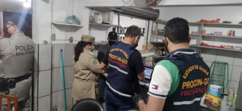 Os fiscais do Procon Goiás, em parceria com policiais militares do 38º Batalhão da Polícia Militar e bombeiros, participaram da 21ª edição da Operação Noite Segura na noite da última sexta-feira (25/6). A ação teve como alvo os estabelecimentos comerciais localizados na região Central de Goiânia, principalmente bares e distribuidoras. A iniciativa faz parte do conjunto de ações realizadas pela Secretaria de Segurança Pública para coibir os crimes na região. “A integração entre as forças torna as ações mais efetivas”, aponta o superintendente do Procon Goiás, Alex Augusto Vaz Rodrigues. Durante a operação, os fiscais do Procon Goiás autuaram 3 estabelecimentos pela venda de produtos impróprios para o consumo (com o prazo de validade vencido, sem procedência ou armazenados de forma irregular). Os responsáveis pelos estabelecimentos podem pagar multa a partir de R$ 680, a depender da natureza do tamanho do estabelecimento, natureza da infração e eventual reincidência.
