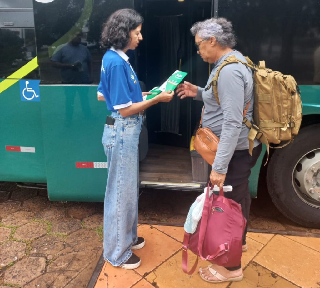 idosa embraca em ônibus e recebe informações da AGR